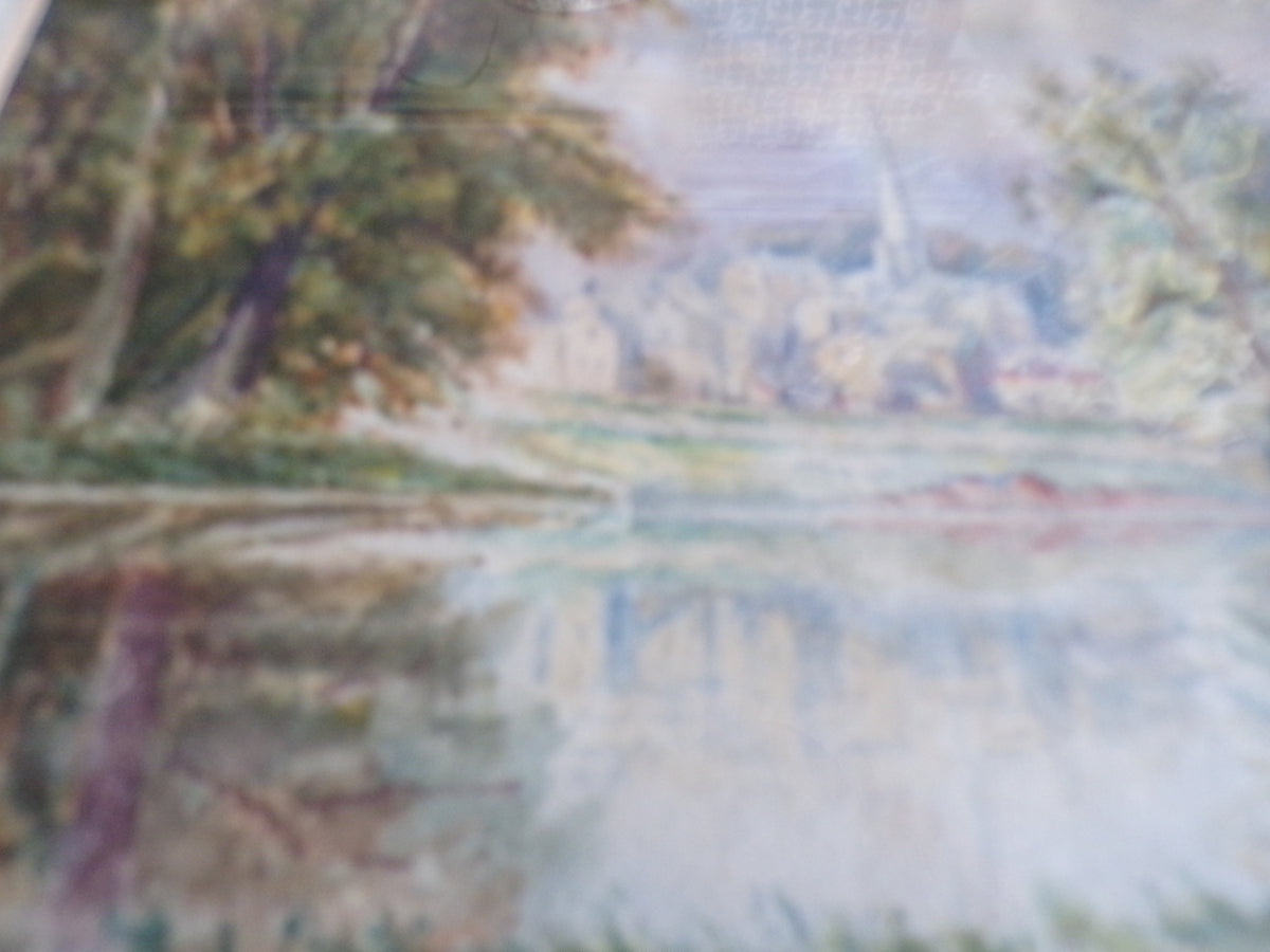 Framed W Bates watercolour of a lake and town scene.