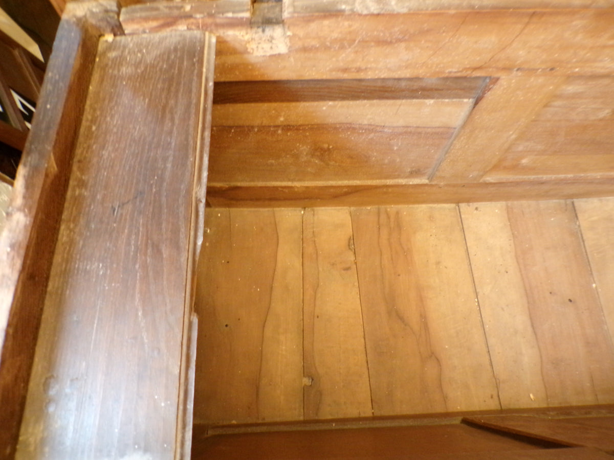Seventeenth Century oak coffer with tulip and leafage carving surrounding two geometric mouldedpanels.