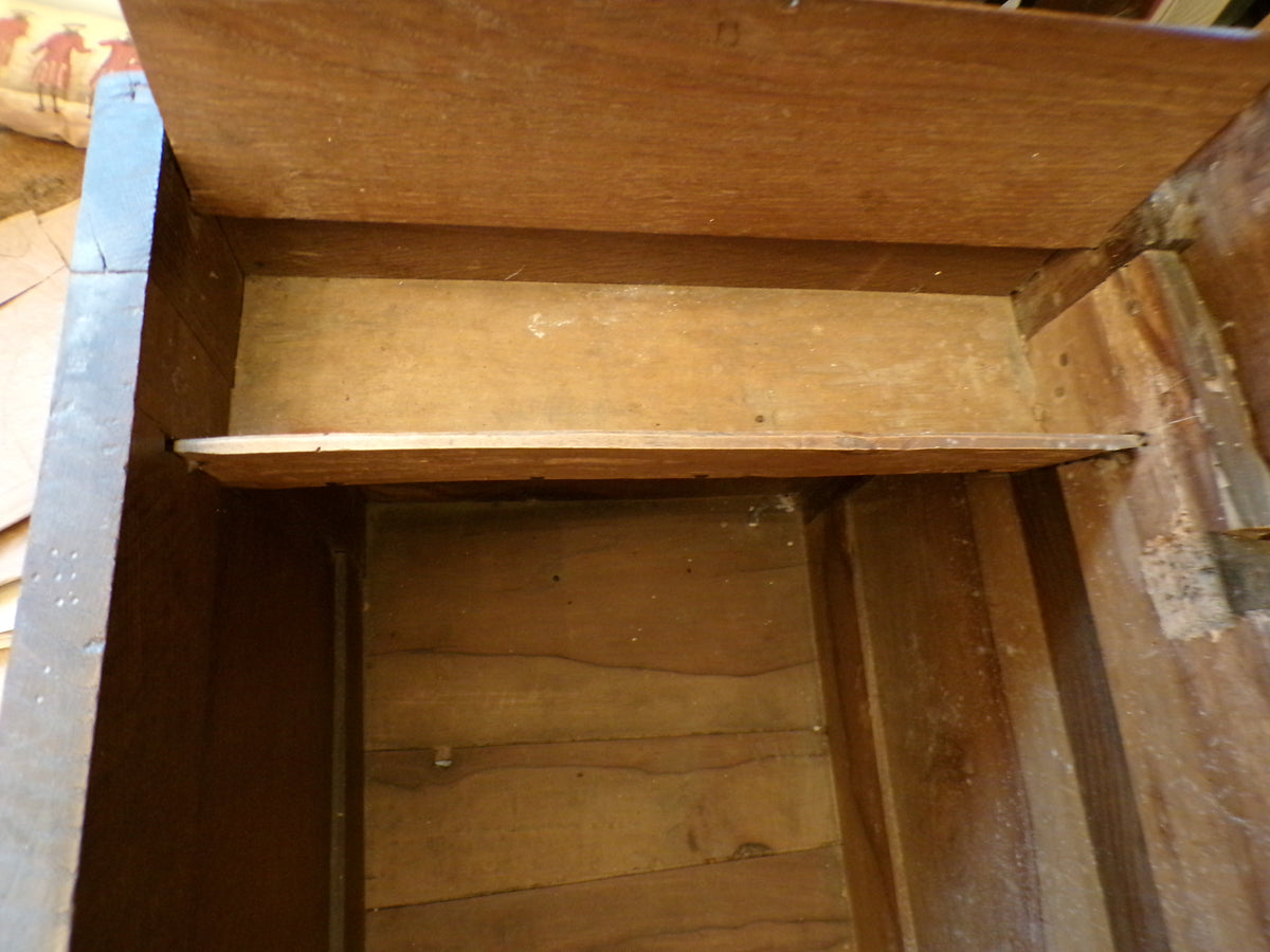 Seventeenth Century oak coffer with tulip and leafage carving surrounding two geometric mouldedpanels.