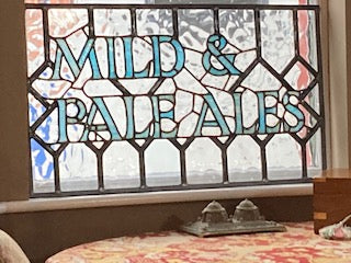 Vintage leaded pub windows with different drinks written on them